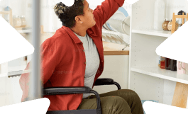 Woman in a wheelchair reaching for a shelf, representing TPD insurance cover